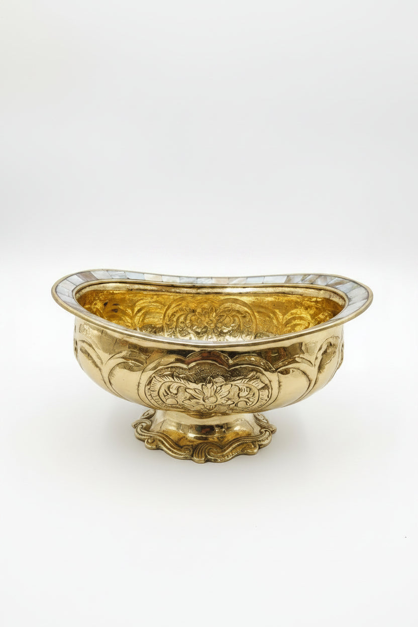 Decorative gold bowl with intricate patterns on a white background