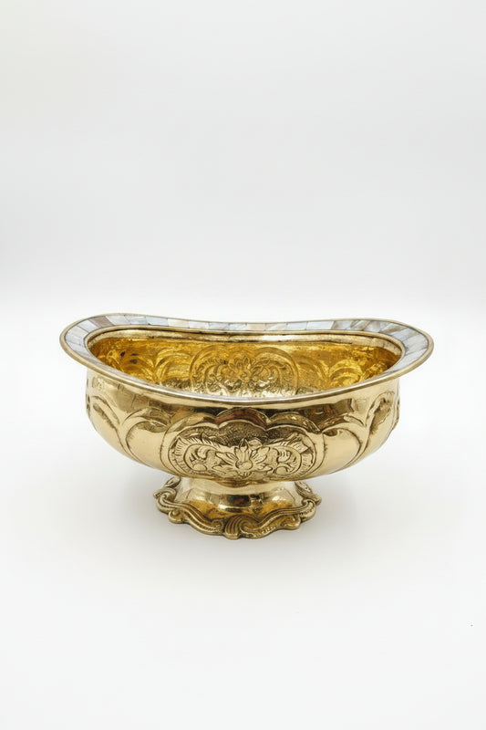 Decorative gold bowl with intricate patterns on a white background