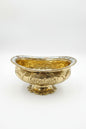 Decorative gold bowl with intricate patterns on a white background
