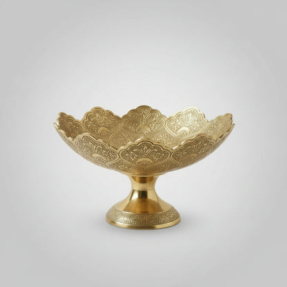 Decorative gold bowl with intricate patterns on a white background