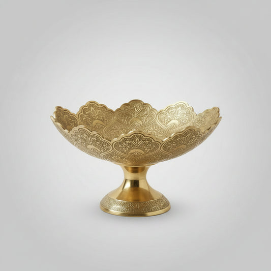 Decorative gold bowl with intricate patterns on a white background