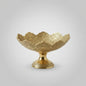 Decorative gold bowl with intricate patterns on a white background