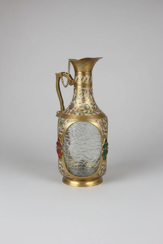 Decorative vase with gold accents on a metallic surface